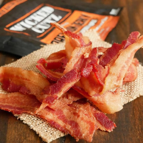 Crispy, handcrafted bacon jerky from Wicked Cutz, featuring thick-cut, smoky, and perfectly seasoned strips. The ultimate savory snack for bacon lovers, featured in the Best Bacon Jerky of 2025 rankings.