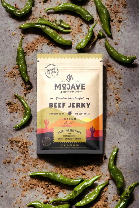 Sugar Free Beef Jerky by Mojave Jerky Co. surrounded by hatch green chiles
