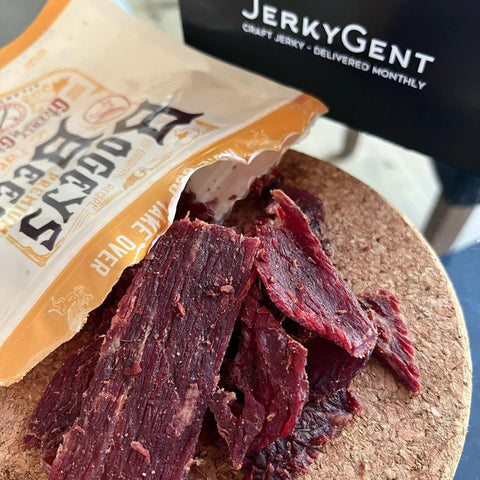 A close-up of Bogey's Beef Gnarly Garly beef jerky coming out of the packaging that showcases the jerky's texture and color