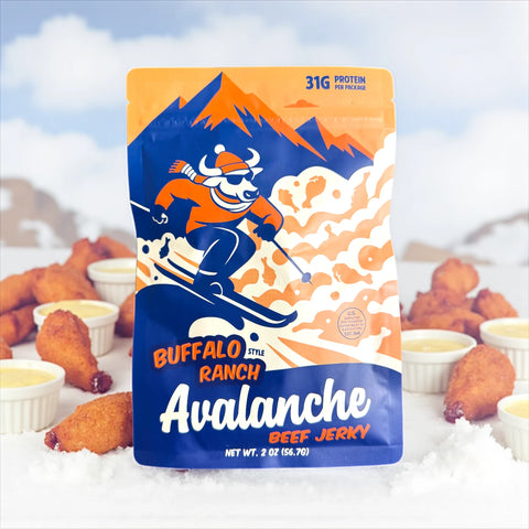Buffalo ranch avalanche beef jerky with chicken wings and ranch dressing in the background.
