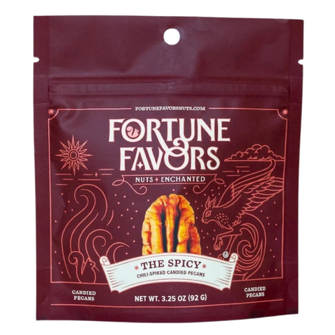 Bag of Fortune Favors 'The Spicy' chili-spiked candied pecans. Deep red packaging with mystical line art of a phoenix and waves, featuring a golden pecan and the tagline 'Nuts Enchanted.'