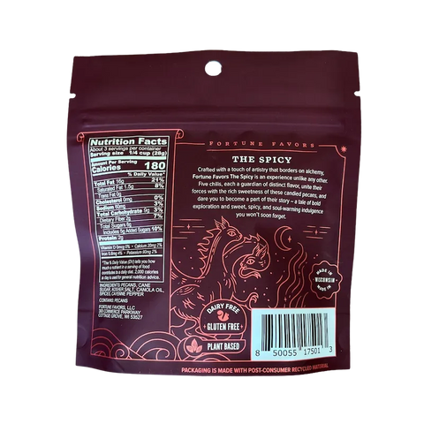 Back of Fortune Favors 'The Spicy' candied pecans bag, featuring a flavor description, nutrition facts, and ingredient list. The design includes fiery red mystical artwork with a dragon, and icons indicating the product is dairy-free, gluten-free, plant-based, and made in Wisconsin.