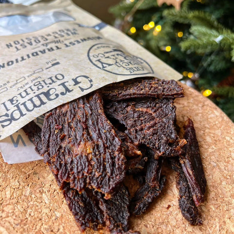 A close-up photo of Gramps Original beef jerky coming out of the packaging showing the texture of the jerky