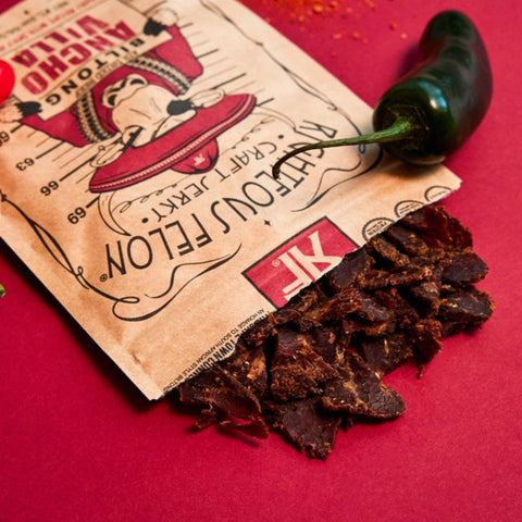 A close-up photo of Righteous Felon Ancho Villa coming out of the packaging to showcase the unique biltong jerky style