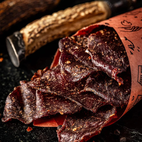 gourmet venison jerky slices in rustic paper cone