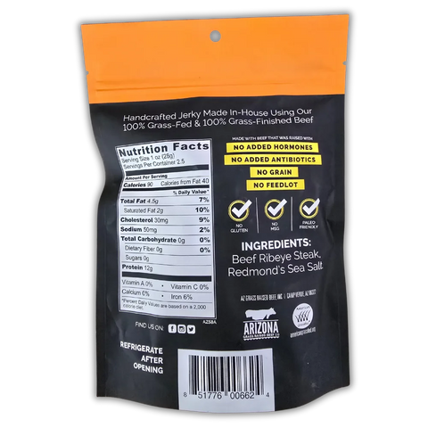 Back of a “Praise the Graze – Eye of the Tiger” beef jerky bag. The packaging features a black and orange color scheme with nutrition facts, ingredient list, and product highlights. Claims include “100% Grass-Fed & Finished Beef,” “No Added Hormones,” “No Antibiotics,” “No Grain,” “No Feedlot,” and icons for No Gluten, No MSG, and Paleo Friendly. Ingredients listed are Beef Ribeye Steak and Redmond’s Sea Salt. Barcode and Arizona Grass Raised Beef Co. branding are visible at the bottom.