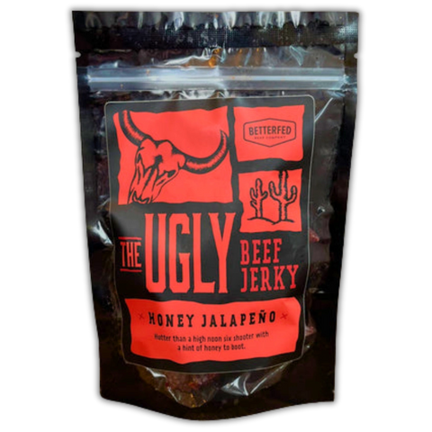 Bag of The Ugly Beef Jerky by Betterfed Meat Co. – Honey Jalapeño flavor with red label featuring a steer skull and desert cactus icons.
