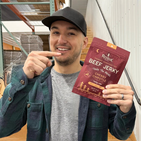 Brad pointing at his favorite: Rogue Jerky Co.’s Cherry Chipotle jerky, in front of the warehouse shelving at JerkyGent.
