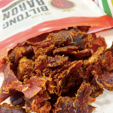 Fresh and Delicious Biltong Baron Cowboys & Campfires Flavor Spilling Out of Bag Onto Tabl