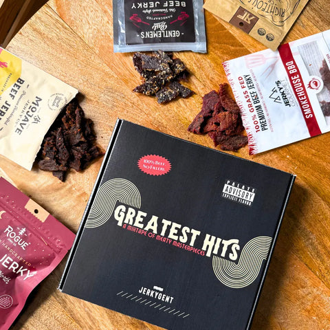 JerkyGent Greatest Hits beef jerky gift box surrounded by premium craft jerky bags from top brands — the ultimate snack sampler for jerky lovers in 2025