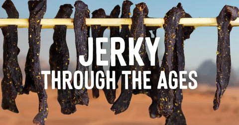 Strips of dried beef jerky hanging on a wooden rod with desert mountains in the background, overlaid with the title 'Jerky Through the Ages'