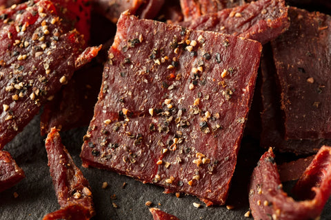 Close-up of peppered beef jerky with a bold, spicy seasoning blend, showcasing its rich texture and savory flavor.