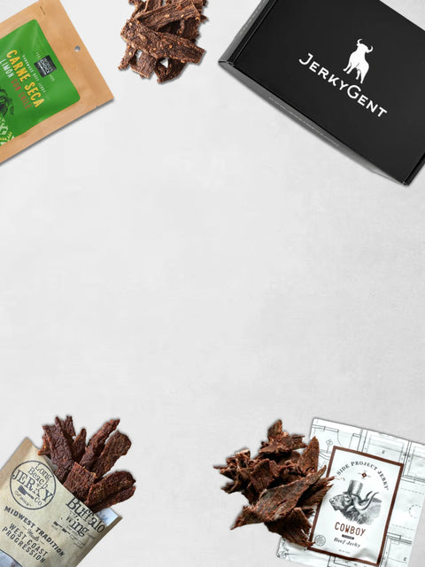 JerkyGent Beef Jerky Subscription Box with delicious beef jerky sprawling out over a table
