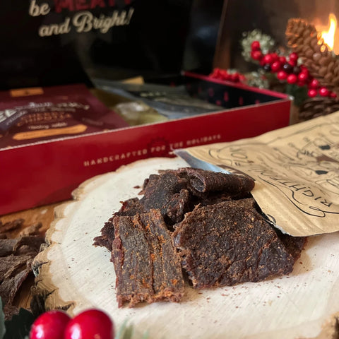 Beef jerky gift box with jerky opened and on a table.