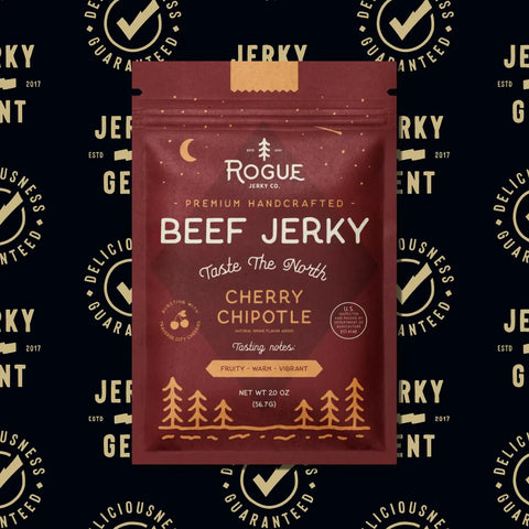 Packaging of Rogue Beef Jerky Co. Cherry Chipotle beef jerky on a patterned background.