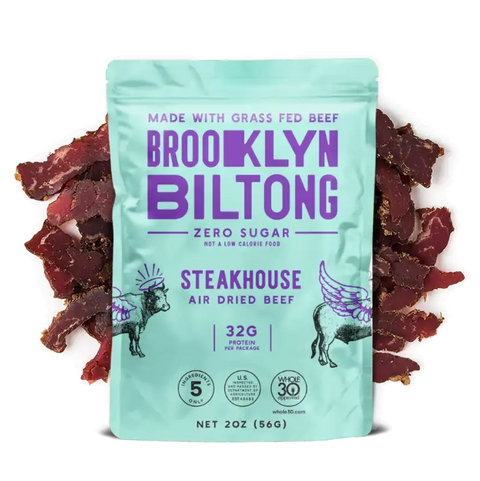 Brooklyn biltong zero sugar beef biltong steakhouse flavor showing the aqua packaging surrounded by fresh biltong