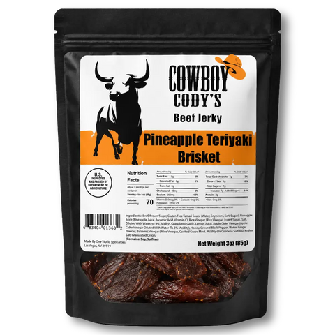 A black stand-up pouch of Cowboy Cody's Beef Jerky, Pineapple Teriyaki Brisket, featuring a white and orange label with a cow graphic and a clear window showing the dark brown jerky inside.