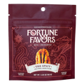 Bag of Fortune Favors 'The Spicy' chili-spiked candied pecans. Deep red packaging with mystical line art of a phoenix and waves, featuring a golden pecan and the tagline 'Nuts Enchanted.'