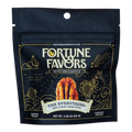 Bag of Fortune Favors 'The Everything' sweet & savory candied pecans. The packaging is dark with gold celestial and mystical illustrations, featuring a central image of a pecan and the tagline 'Nuts Enchanted.