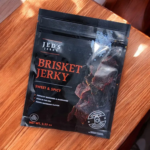 Jed's Jerky Sweet & Spicy tender brisket jerky on wooden table