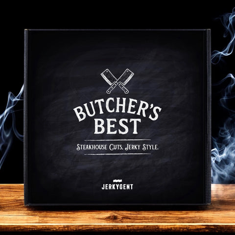 Butchers Best Steakhouse Beef Jerky Gift Box on a butcher block with smoke in the background.