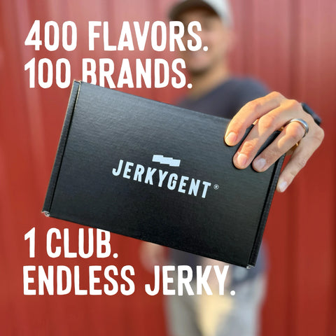 Person holding a beef jerky subscription box with 'Jerkygent' branding against a red curtain background.