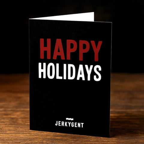 Black card with 'Happy Holidays' text and Jerkygent branding on a wooden surface.