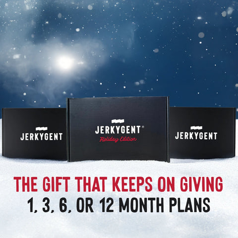 Three JerkyGent Holiday Edition gift boxes displayed in snowy scenery with text reading “The Gift That Keeps On Giving – 1, 3, 6, or 12 Month Plans” against a winter night sky.