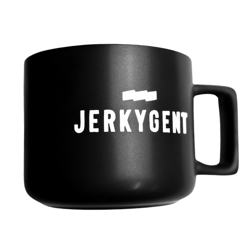 Matte black JerkyGent coffee mug with bold white logo.
