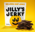 Jillys black pepper beef jerky with a pile of thin cut jerky next to it.