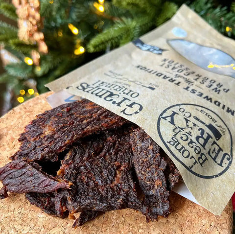 Long Beach Jerky Co super fresh gramps brisket beef jerky spilling out the bag onto a table