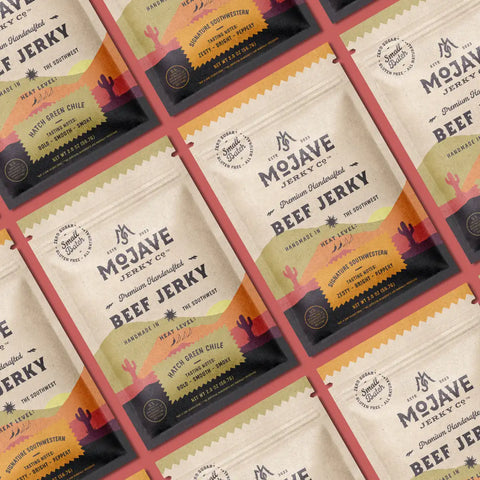 Mojave Jerky Co. - Sugar free beef jerky flavor options on a red table, including Hatch Green Chile and Signature Southwestern.