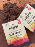 Mojave Red Rock Chipotle lifestyle photo showing the jerky on red rocks
