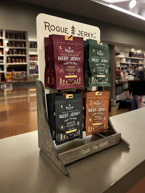 Wholesale beef jerky in a retail location showing 4 flavors of beef jerky on a store counter.