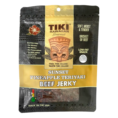 Bag of Tiki Hawaiian Gourmet Sunset Pineapple Teriyaki Beef Jerky, featuring a tropical-themed design with tiki mask, hibiscus flower, and clear window showing tender brisket jerky.