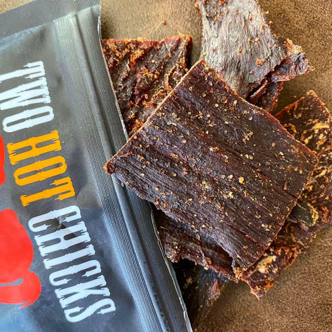 A close-up photo of fresh habanero beef jerky by Two Chicks, which showcases the hot and spicy peppers infused into the beef