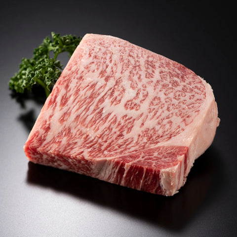 A close-up photo of a square piece of raw wagyu that shows the intricate marbling of wagyu meat