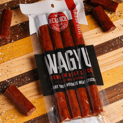 Wagyu beef sticks by RC Ranch Texas Craft Meats - Chopped on a cutting board.