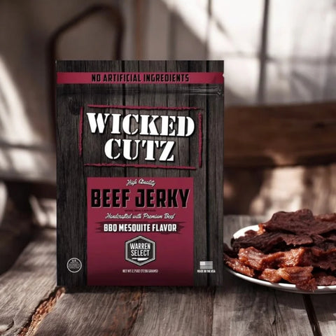 Wicked Cutz BBQ Mesquite tender beef jerky on rustic wooden table with plate of jerky