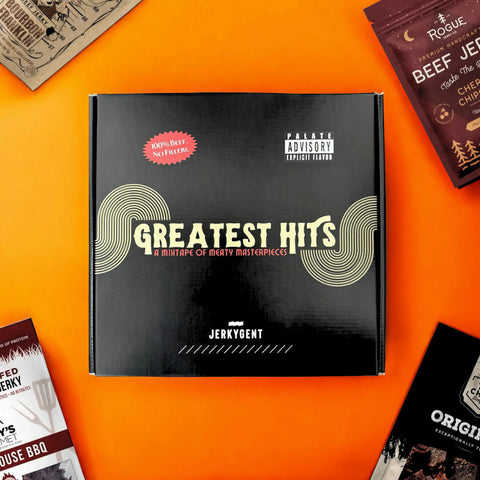 JerkyGent Greatest Hits beef jerky gift box with the tagline 'A Mixtape of Meaty Masterpieces' on an orange background, surrounded by premium jerky packs.