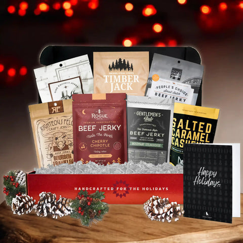 Holiday beef jerky gift box from JerkyGent featuring premium jerky brands with festive packaging, pinecones, and a 'Happy Holidays' card included.